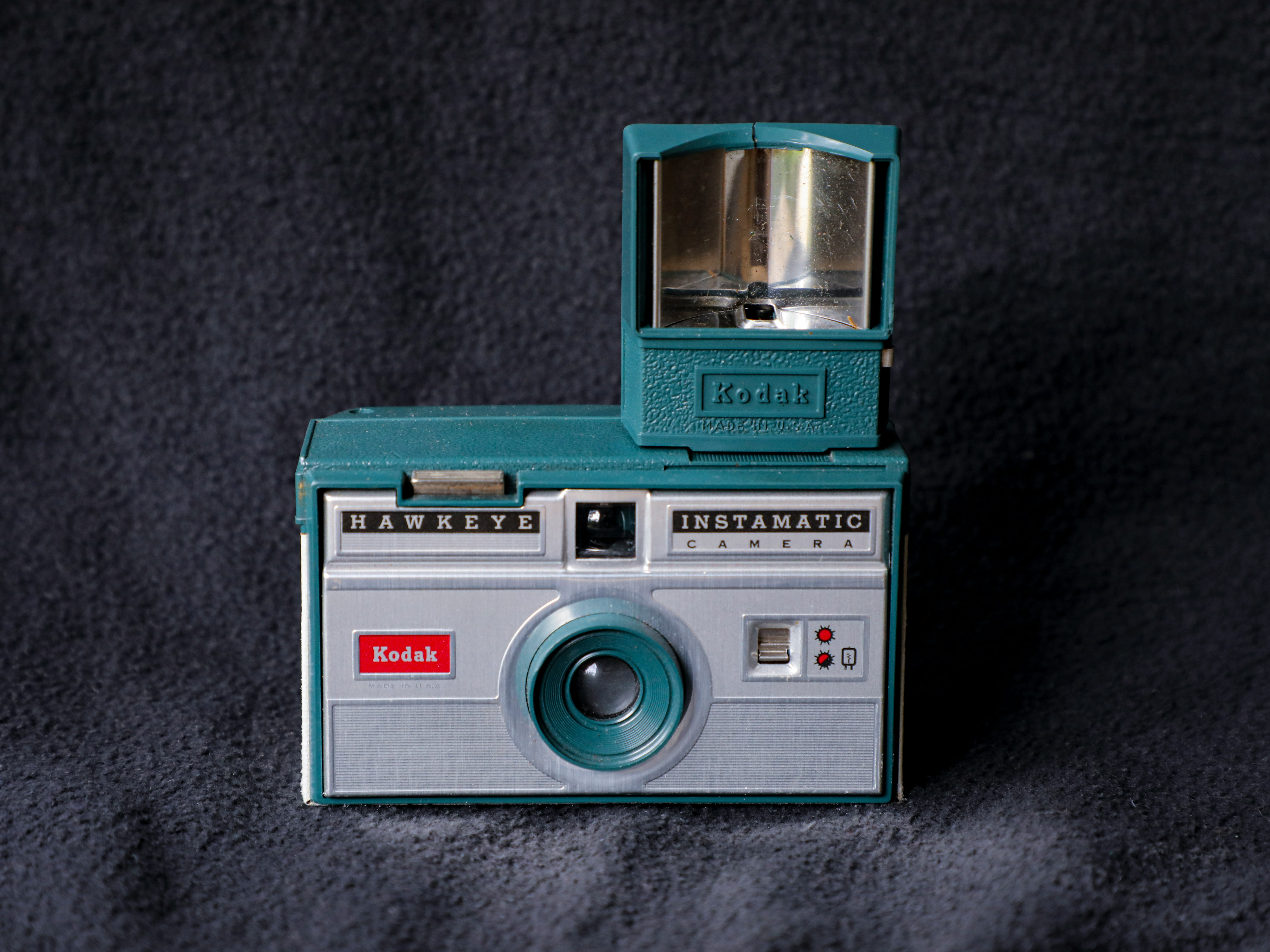 teal and silver point and shoot camera